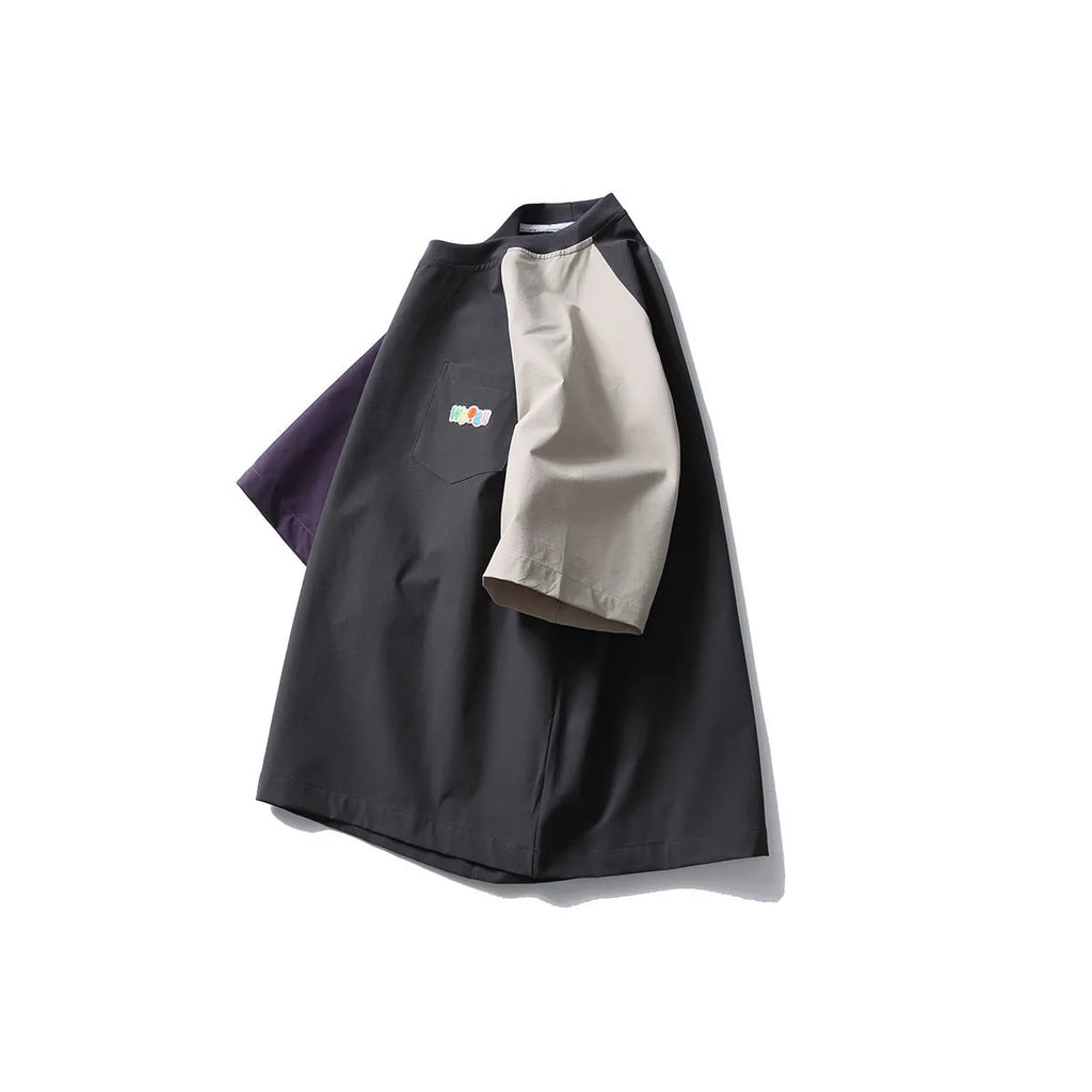 Dark grey men's loose fit t-shirt with contrasting colour raglan sleeves on a hanger.