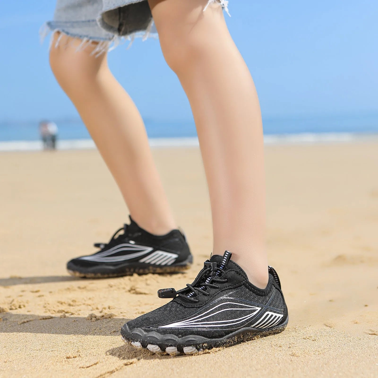 Children's black quick-drying wading shoes with non-slip rubber sole and elastic band.