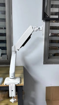 Black rotating telescopic LCD screen bracket elevating a monitor on a desk.