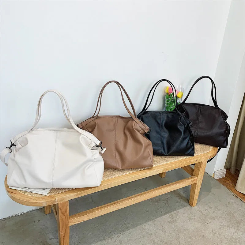 Large horizontal PU messenger bag with soft surface and shoulder strap in black colour