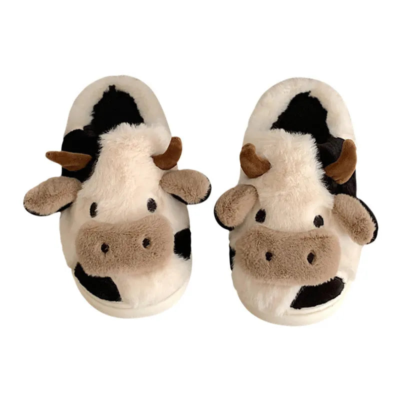 White cow print faux fur plush slippers for women with a non-slip textured sole.