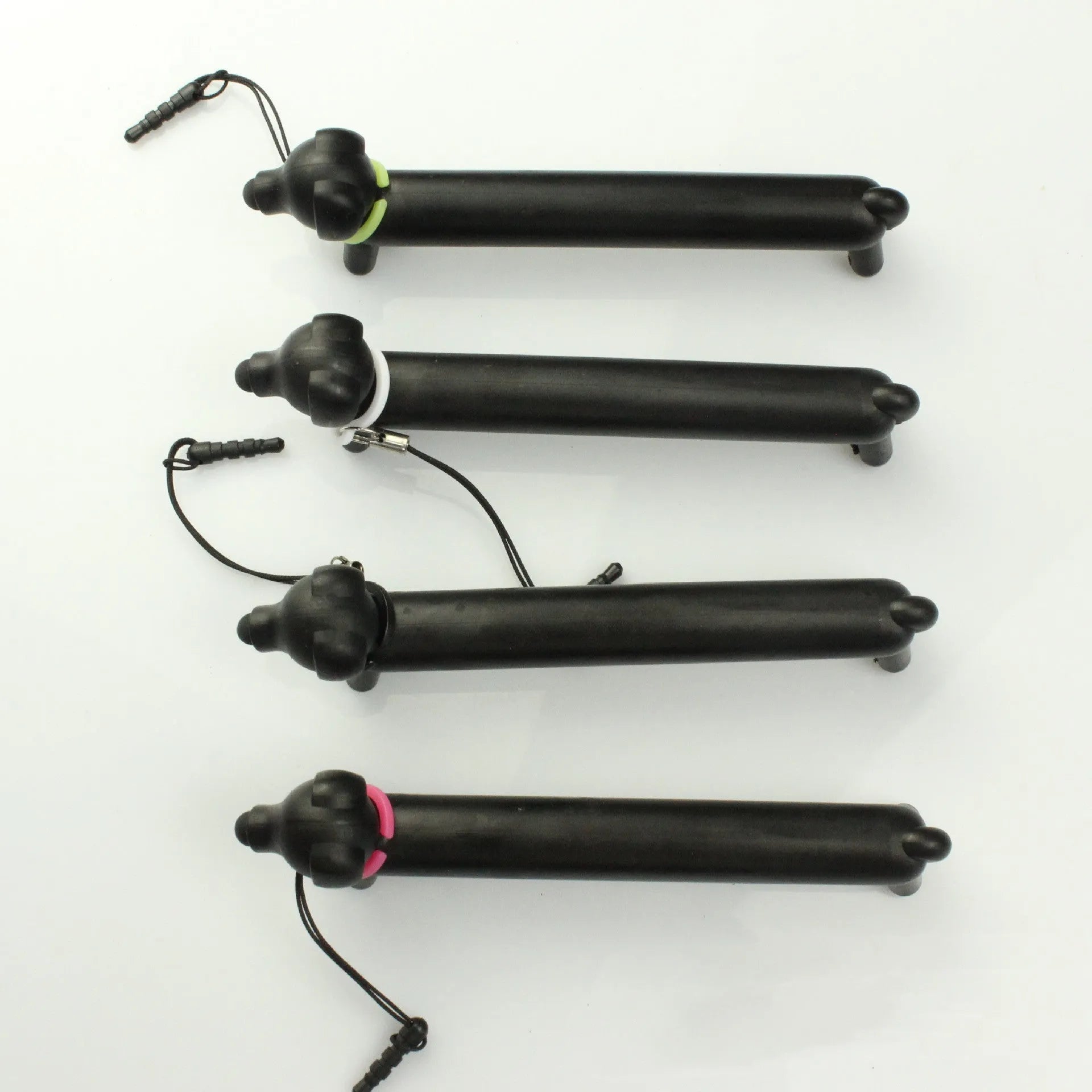 Black dog-shaped touch screen stylus showing length adjustment and phone stand functionality