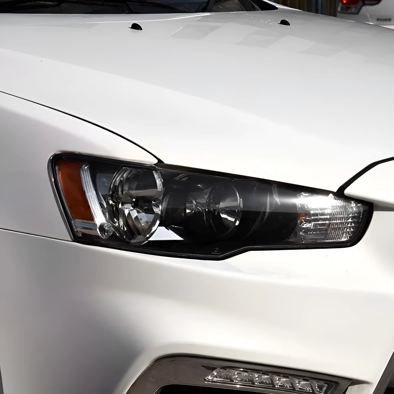 Transparent plastic headlight housing cover measuring 50mm by 30mm by 20mm