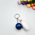 Miniature bowling ball keychain in four colour options: dark red, blue, purple, green