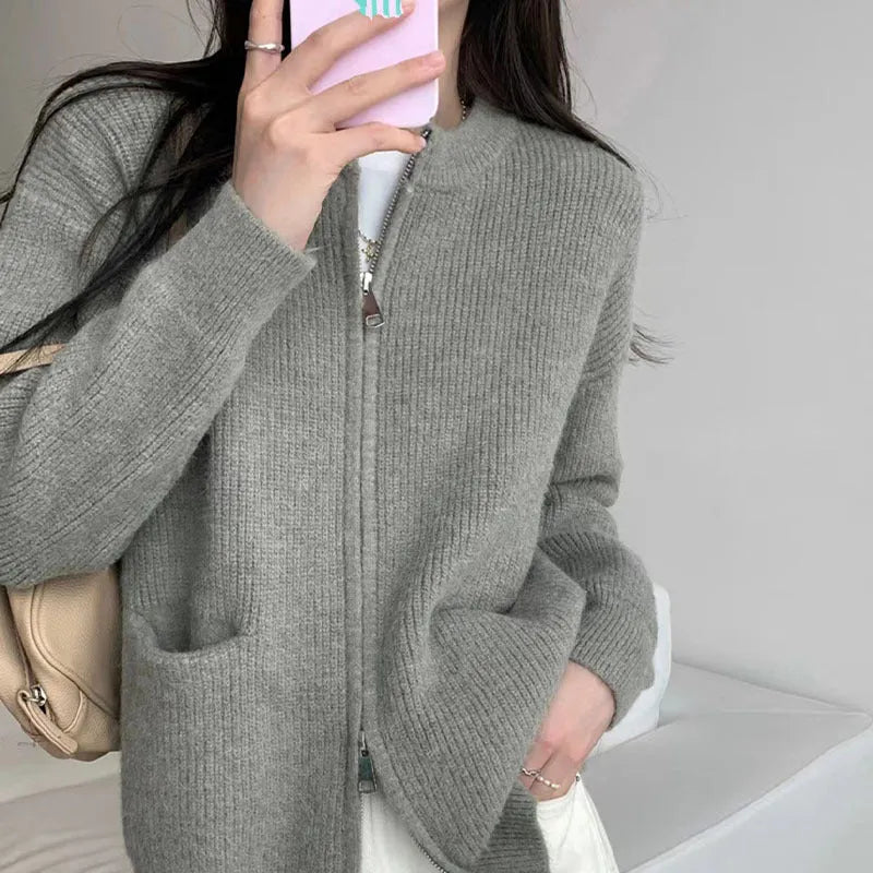 Beige viscose fibre long sleeve cardigan sweater coat laid flat, showing button front and soft texture.