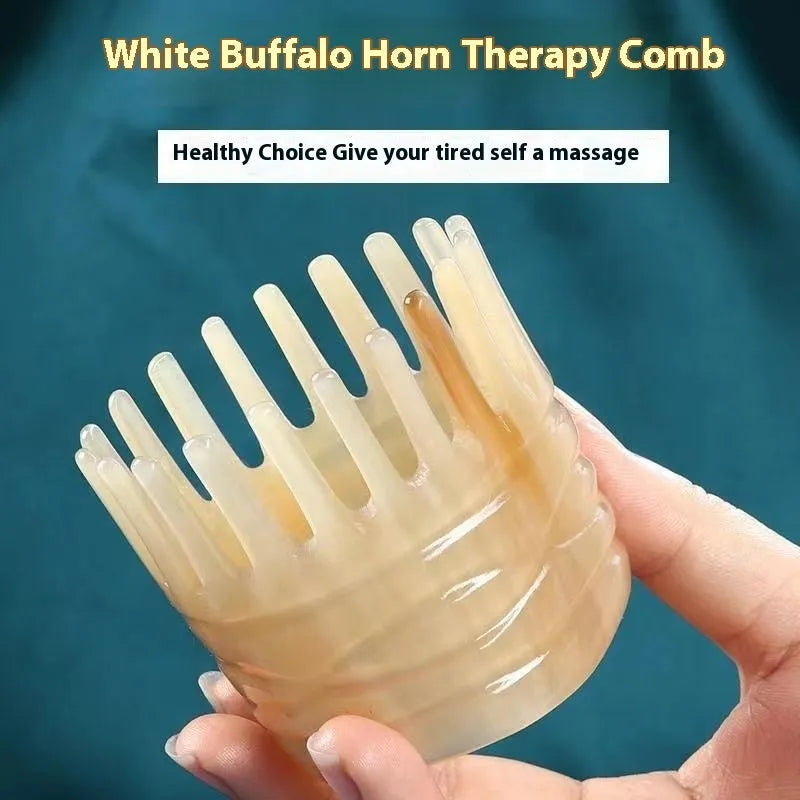 White buffalo horn comb with wide teeth on one side and pointed tips for head meridian massage.