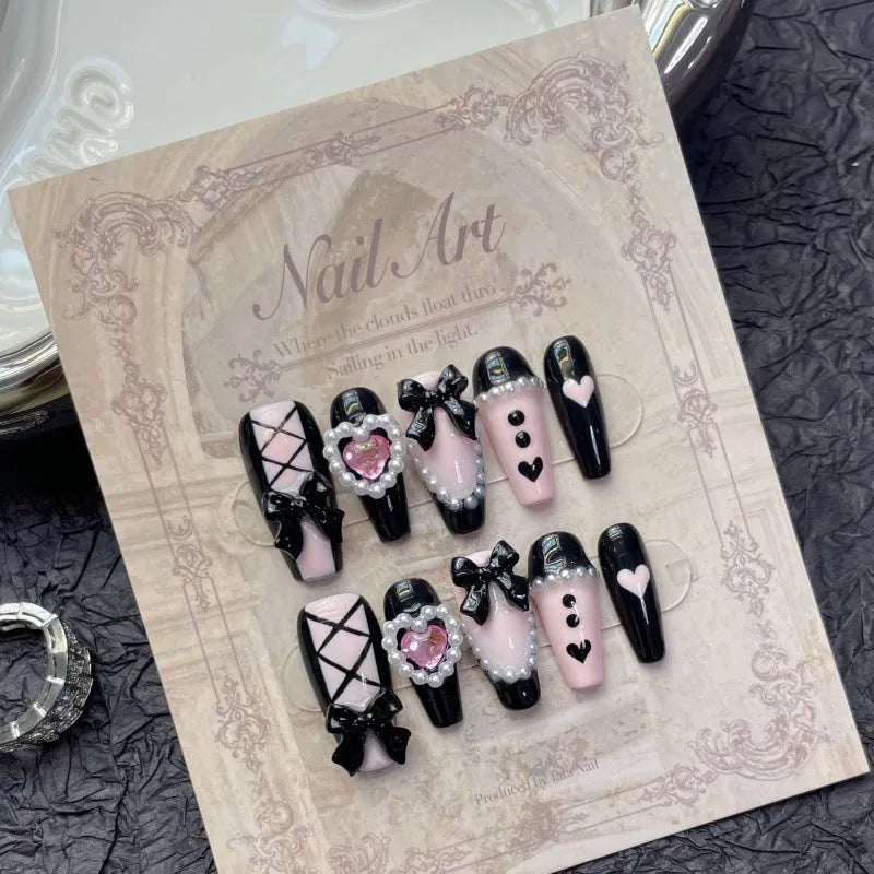 Black and pink peach heart hand-painted artificial nails with bow patterns in cat's eye finish