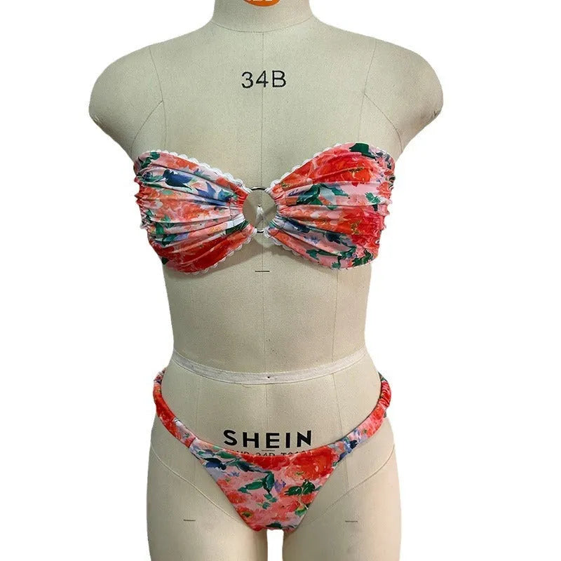 Women's floral print bikini set with lace trim on a tube top and briefs in blue.